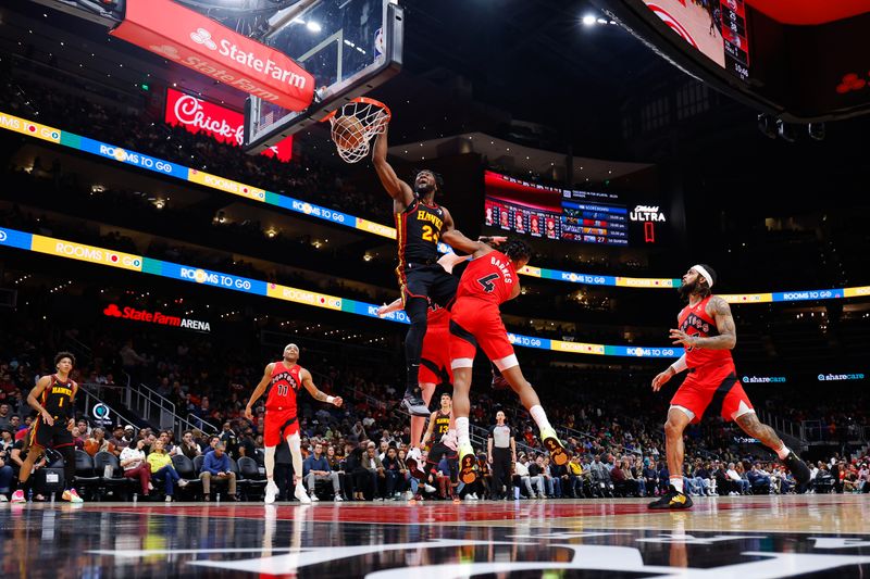 ATLANTA, GEORGIA - FEBRUARY 23: Bruno Fernando #24 of the Atlanta Hawks dunks during the second quarter against the Toronto Raptors at State Farm Arena on February 23, 2024 in Atlanta, Georgia. NOTE TO USER: User expressly acknowledges and agrees that, by downloading and or using this photograph, User is consenting to the terms and conditions of the Getty Images License Agreement. (Photo by Todd Kirkland/Getty Images)