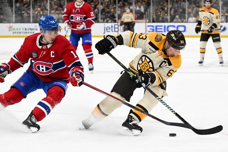 Jan 20, 2024; Boston, Massachusetts, USA; Boston Bruins left wing Brad Marchand (63) controls the puck against Montreal Canadiens center Nick Suzuki (14) during the third period at the TD Garden. Mandatory Credit: Brian Fluharty-USA TODAY Sports