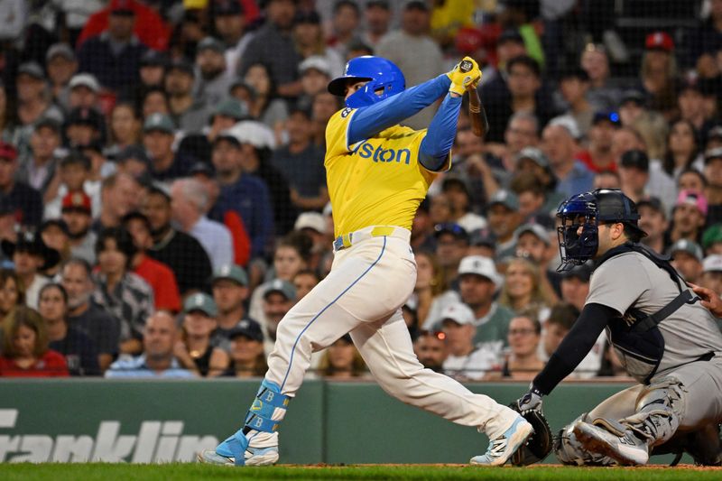 Sep 13, 2025; Boston, Massachusetts, USA; Boston Red Sox catcher Connor Wong (12) hits a one run RBI single against the New York Yankees during sixth inning  at Fenway Park. Mandatory Credit: Eric Canha-Imagn Images