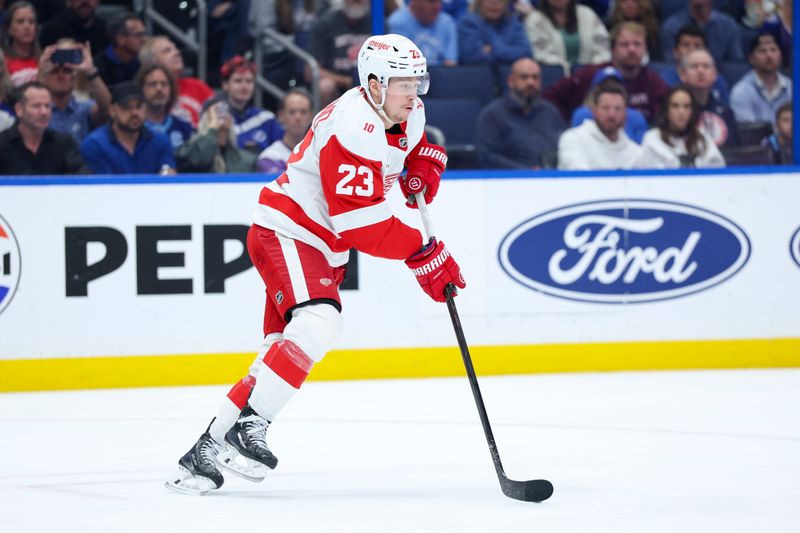 Mar 12, 2026; Tampa, Florida, USA; Detroit Red Wings left wing Lucas Raymond (23) controls the puck against the Tampa Bay Lightning in the first period at Benchmark International Arena. Mandatory Credit: Nathan Ray Seebeck-Imagn Images