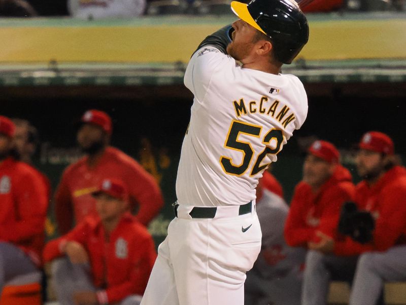 Apr 16, 2024; Oakland, California, USA; Oakland Athletics catcher Kyle McCann (52) hits a solo home run against the St. Louis Cardinals during the fifth inning at Oakland-Alameda County Coliseum. Mandatory Credit: Kelley L Cox-USA TODAY Sports