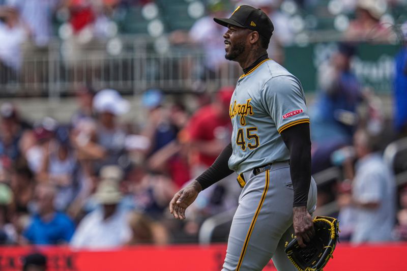 Jun 30, 2024; Cumberland, Georgia, USA; Pittsburgh Pirates relief pitcher Aroldis Chapman (45) reacts after defeating the Atlanta Braves at Truist Park. Mandatory Credit: Dale Zanine-USA TODAY Sports