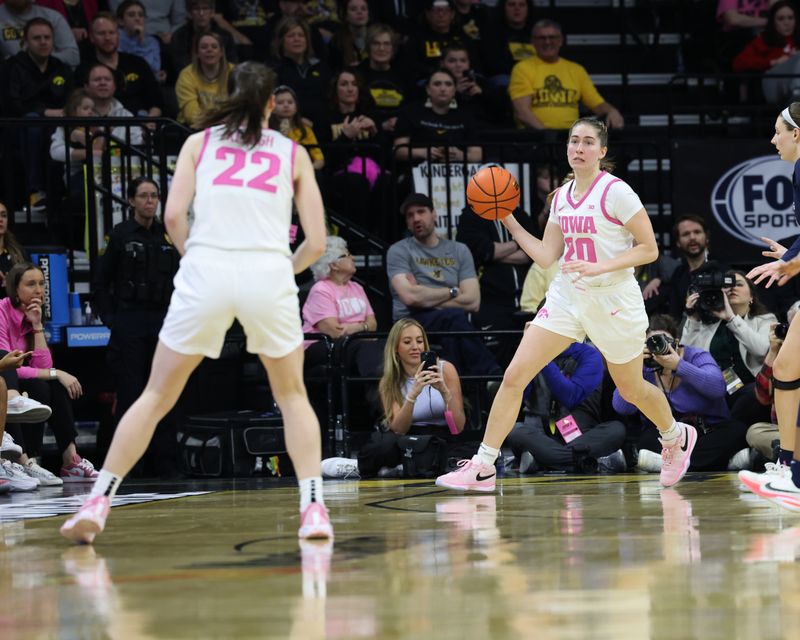 Feb 25, 2024; Iowa City, Iowa, USA; Iowa Hawkeyes guard Kate Martin (20) passes to Iowa Hawkeyes guard Caitlin Clark (22) against the Illinois Fighting Illini during the second half at Carver-Hawkeye Arena. Mandatory Credit: Reese Strickland-USA TODAY Sports