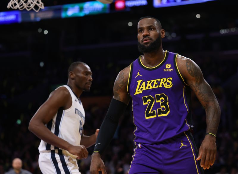 LOS ANGELES, CALIFORNIA - JANUARY 05: LeBron James #23 of the Los Angeles Lakers reacts after his dunk in front of Bismack Biyombo #18 of the Memphis Grizzlies during the first half at Crypto.com Arena on January 05, 2024 in Los Angeles, California. User is consenting to the terms and conditions of the Getty Images License Agreement. (Photo by Harry How/Getty Images)