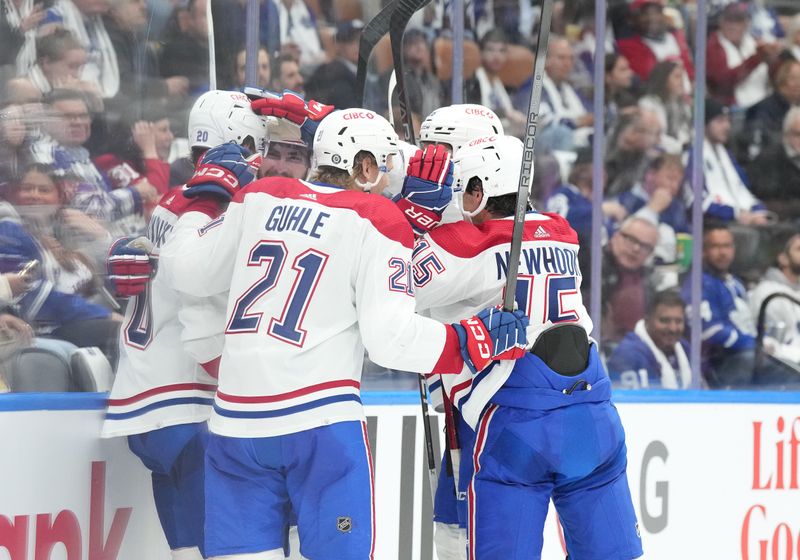 Oct 11, 2023; Toronto, Ontario, CAN; Montreal Canadiens center Alex Newhook (15) scores a goal and celebrates with defenseman Kaiden Guhle (21) against the Toronto Maple Leafs during the second period at Scotiabank Arena. Mandatory Credit: Nick Turchiaro-USA TODAY Sports