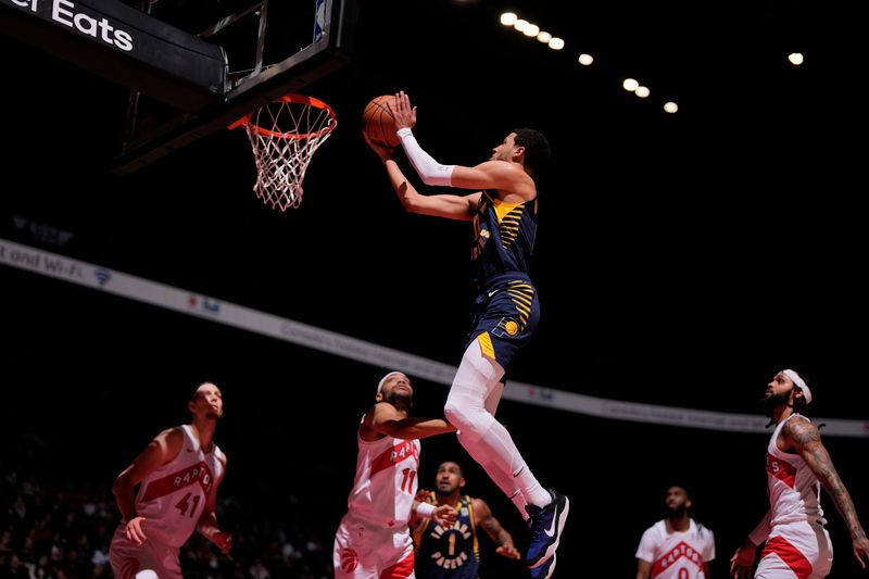 TORONTO, CANADA - APRIL 9: Tyrese Haliburton #0 of the Indiana Pacers drives to the basket during the game against the Toronto Raptors on April 9, 2024 at the Scotiabank Arena in Toronto, Ontario, Canada.  NOTE TO USER: User expressly acknowledges and agrees that, by downloading and or using this Photograph, user is consenting to the terms and conditions of the Getty Images License Agreement.  Mandatory Copyright Notice: Copyright 2024 NBAE (Photo by Mark Blinch/NBAE via Getty Images)