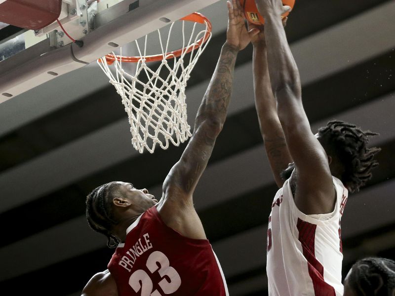 Mar 9, 2024; Tuscaloosa, Alabama, USA;  Alabama forward Nick Pringle (23) attempts to block at shot at the rim by Arkansas forward Makhi Mitchell (15) at Coleman Coliseum. Alabama came from behind to win on overtime 92-88. Mandatory Credit: Gary Cosby Jr.-USA TODAY Sports