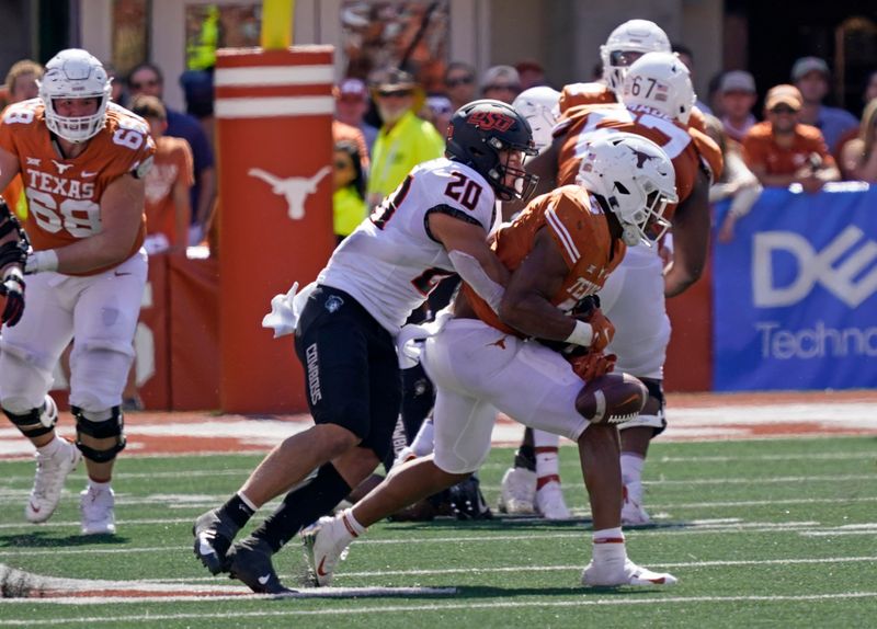 Oct 16, 2021; Austin, Texas, USA; Texas Longhorns running back Bijan Robinson (5) is tackled by Oklahoma State Cowboys linebacker Malcolm Rodriguez (20) in the second half at Darrell K Royal-Texas Memorial Stadium. Mandatory Credit: Scott Wachter-USA TODAY Sports