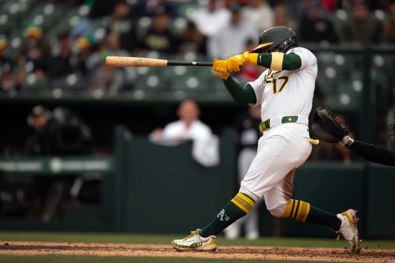 Apr 27, 2025; West Sacramento, California, USA; Athletics second baseman Luis Urías (17) connects for a game-winning two-run home run against the Chicago White Sox during the tenth inning at Sutter Health Park. Mandatory Credit: D. Ross Cameron-Imagn Images