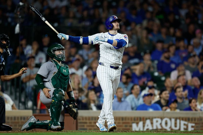 Sep 17, 2024; Chicago, Illinois, USA; Chicago Cubs outfielder Ian Happ (8) hits a solo home run against the Oakland Athletics during the third inning at Wrigley Field. Mandatory Credit: Kamil Krzaczynski-Imagn Images