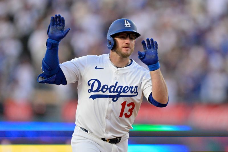 May 15, 2025; Los Angeles, California, USA; Los Angeles Dodgers third baseman Max Muncy (13) celebrates as he rounds the bases after hitting a two-run home run against the Athletics during the first inning of the game at Dodger Stadium. Mandatory Credit: Jayne Kamin-Oncea-Imagn Images