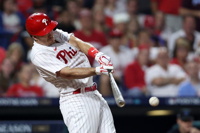 Oct 4, 2023; Philadelphia, Pennsylvania, USA; Philadelphia Phillies catcher J.T. Realmuto (10) hits a double against the Miami Marlins during the second inning for game two of the Wildcard series for the 2023 MLB playoffs at Citizens Bank Park. Mandatory Credit: Bill Streicher-USA TODAY Sports