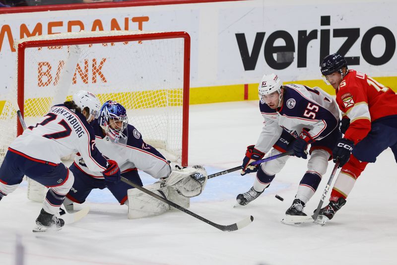 Apr 11, 2024; Sunrise, Florida, USA; Columbus Blue Jackets defenseman Nick Blankenburg (77), goaltender Jet Greaves (73) and defenseman David Jiricek (55) defend against Florida Panthers center Anton Lundell (15) during the first period at Amerant Bank Arena. Mandatory Credit: Sam Navarro-USA TODAY Sports