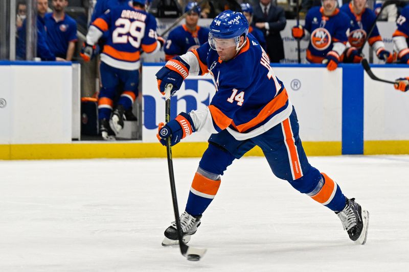 Oct 23, 2025; Elmont, New York, USA;  New York Islanders center Bo Horvat (14) attmepts a shot against the Detroit Red Wings during the second period at UBS Arena. Mandatory Credit: Dennis Schneidler-Imagn Images