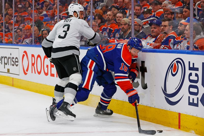 Apr 22, 2024; Edmonton, Alberta, CAN; Edmonton Oilers forward Zach Hyman (18) protects the puck from Los Angeles Kings defensemen Matt Roy (3) during the first period in game one of the first round of the 2024 Stanley Cup Playoffs at Rogers Place. Mandatory Credit: Perry Nelson-USA TODAY Sports