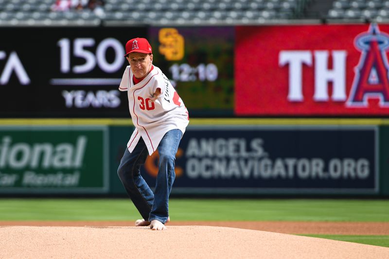 Oct 1, 2023; Anaheim, California, USA; Tom Willis throws the first pitch at the game between the Oakland Athletics and Los Angeles Angels at Angel Stadium. Mandatory Credit: Jonathan Hui-USA TODAY Sports