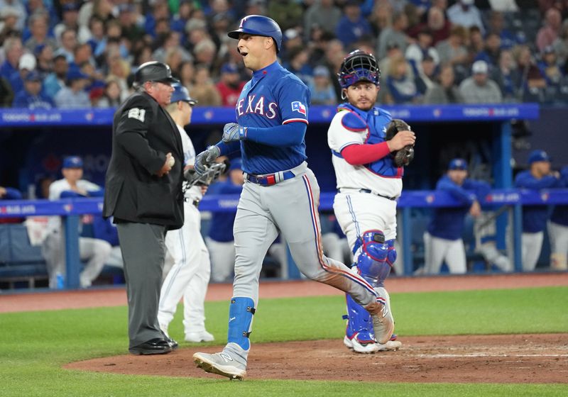 Sep 13, 2023; Toronto, Ontario, CAN; Texas Rangers first baseman Nathaniel Lowe (30) crosses home plate after hitting a three run home run against the Toronto Blue Jays during the fourth inning at Rogers Centre. Mandatory Credit: Nick Turchiaro-USA TODAY Sports