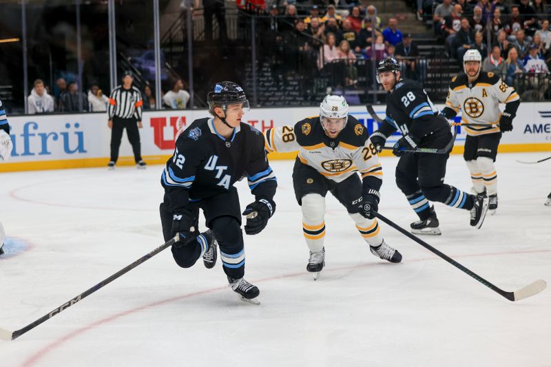 Oct 19, 2024; Salt Lake City, Utah, USA; Utah Hockey ClubAlexander Kerfott (15( fights for the puck first period against Elias Lindholm (28) at Delta Center. Mandatory Credit: Harry Caston-Imagn Images