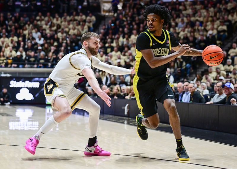 Feb 7, 2026; West Lafayette, Indiana, USA; Oregon Ducks guard Takai Simpkins (5) drives the ball past Purdue Boilermakers guard Braden Smith (3) during the first half at Mackey Arena. Mandatory Credit: Marc Lebryk-Imagn Images