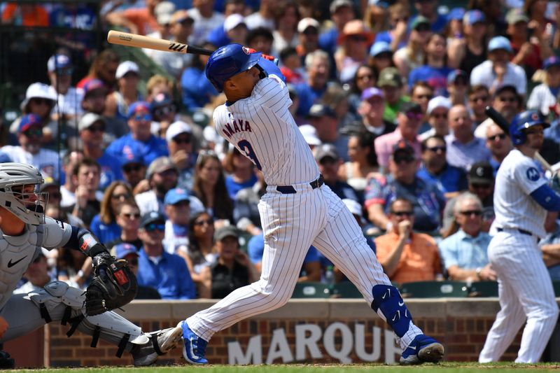 Aug 22, 2024; Chicago, Illinois, USA; Chicago Cubs catcher Miguel Amaya (9) hits a grand slam during the second inning against the Detroit Tigers at Wrigley Field. Mandatory Credit: Patrick Gorski-USA TODAY Sports
