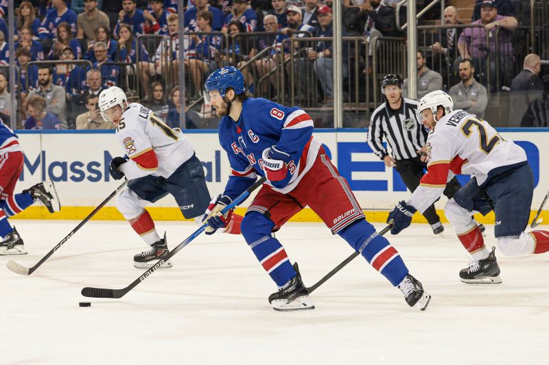 May 24, 2024; New York, New York, USA; New York Rangers defenseman Jacob Trouba (8) plays the puck against Florida Panthers center Carter Verhaeghe (23) during the first period in game two of the Eastern Conference Final of the 2024 Stanley Cup Playoffs at Madison Square Garden. Mandatory Credit: Vincent Carchietta-USA TODAY Sports