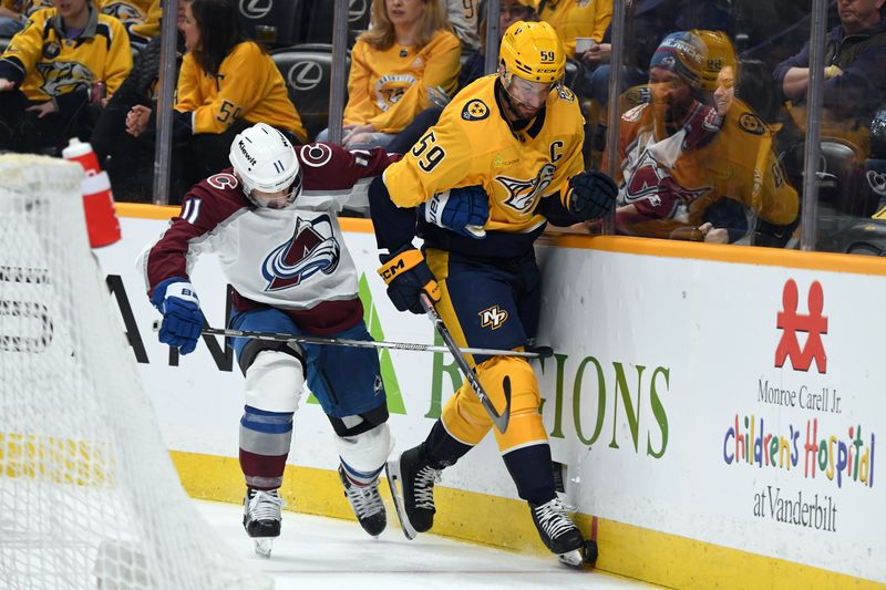 Mar 2, 2024; Nashville, Tennessee, USA; Nashville Predators defenseman Roman Josi (59) and Colorado Avalanche center Andrew Cogliano (11) skate for a loose puck during the second period at Bridgestone Arena. Mandatory Credit: Christopher Hanewinckel-USA TODAY Sports