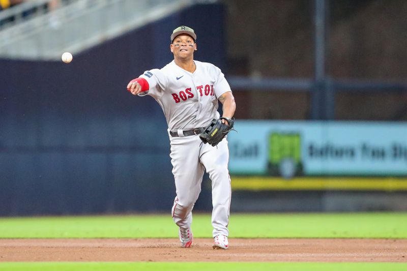 May 20, 2023; San Diego, California, USA; Boston Red Sox third baseman Rafael Devers (11) throws to first base to record the out in the first inning against the San Diego Padres at Petco Park. Mandatory Credit: David Frerker-USA TODAY Sports