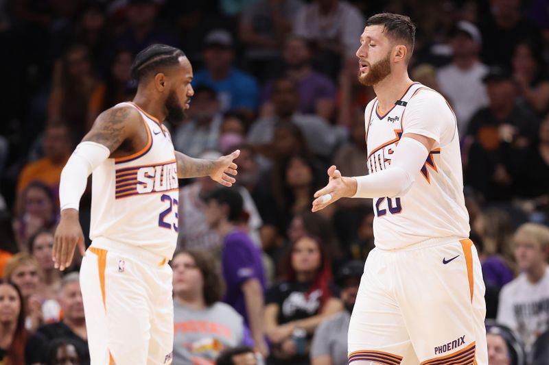 PHOENIX, ARIZONA - OCTOBER 17: Jusuf Nurkic #20 of the Phoenix Suns high fives Monte Morris #23 after scoring against the Los Angeles Lakers during the first half of the preseason NBA game at Footprint Center on October 17, 2024 in Phoenix, Arizona. NOTE TO USER: User expressly acknowledges and agrees that, by downloading and/or using this photograph, user is consenting to the terms and conditions of the Getty Images License Agreement.  (Photo by Christian Petersen/Getty Images)