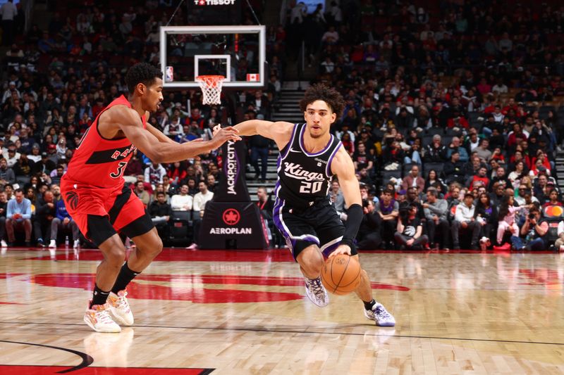 TORONTO, CANADA - MARCH 20: Colby Jones #20 of the Sacramento Kings dribbles the ball during the game against the Toronto Raptors on March 20, 2024 at the Scotiabank Arena in Toronto, Ontario, Canada.  NOTE TO USER: User expressly acknowledges and agrees that, by downloading and or using this Photograph, user is consenting to the terms and conditions of the Getty Images License Agreement.  Mandatory Copyright Notice: Copyright 2024 NBAE (Photo by Vaughn Ridley/NBAE via Getty Images)