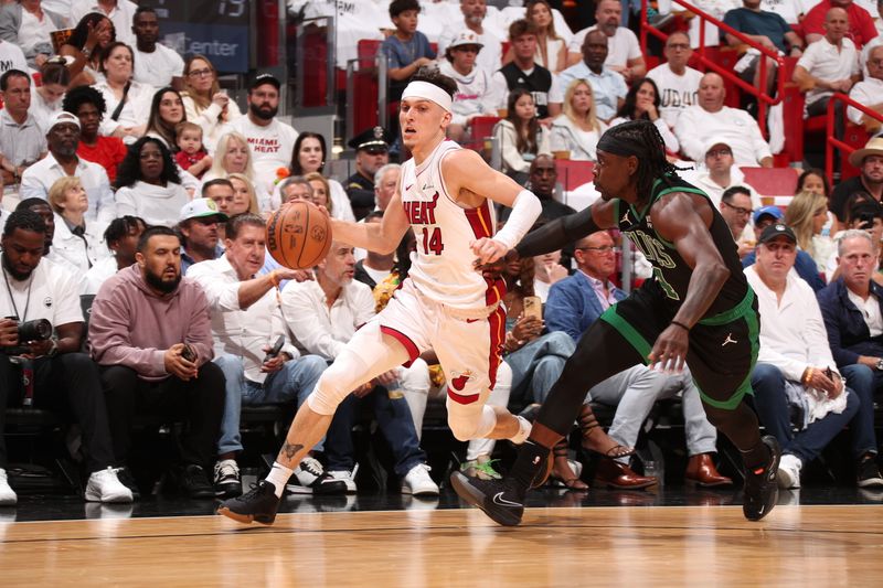 MIAMI, FL - APRIL 27: Tyler Herro #14 of the Miami Heat dribbles the ball during the game against the Boston Celtics during Round 1 Game 3 of the 2024 NBA Playoffs on April 27, 2024 at Kaseya Center in Miami, Florida. NOTE TO USER: User expressly acknowledges and agrees that, by downloading and or using this Photograph, user is consenting to the terms and conditions of the Getty Images License Agreement. Mandatory Copyright Notice: Copyright 2024 NBAE (Photo by Issac Baldizon/NBAE via Getty Images)