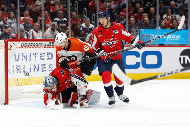 Oct 23, 2024; Washington, District of Columbia, USA; Philadelphia Flyers center Morgan Frost (48) collides with Washington Capitals goaltender Logan Thompson (48) in the second period at Capital One Arena. Mandatory Credit: Geoff Burke-Imagn Images