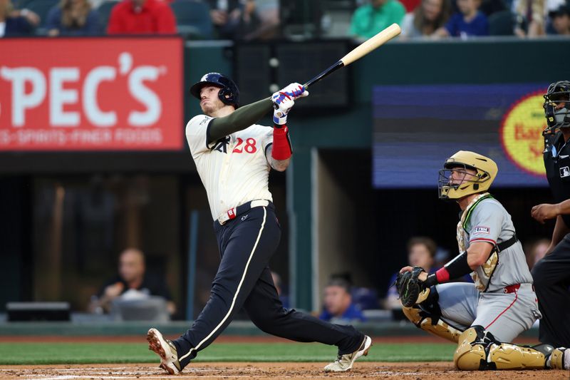 May 17, 2024; Arlington, Texas, USA; Texas Rangers catcher Jonah Heim (28) hits a home run in the second inning against the Los Angeles Angels at Globe Life Field. Mandatory Credit: Tim Heitman-USA TODAY Sports