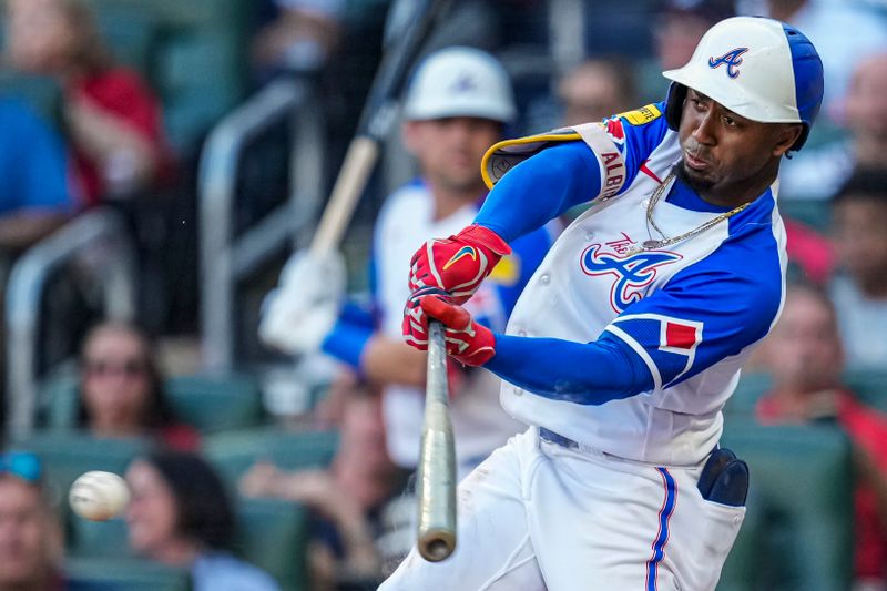 Jul 29, 2023; Cumberland, Georgia, USA; Atlanta Braves second baseman Ozzie Albies (1) singles to drive in a run against the Milwaukee Brewers during the first inning at Truist Park. Mandatory Credit: Dale Zanine-USA TODAY Sports