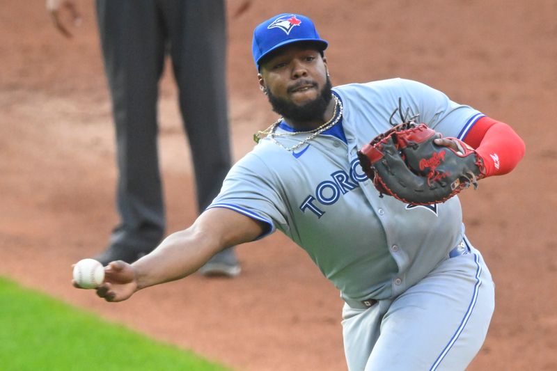 Jun 21, 2024; Cleveland, Ohio, USA; Toronto Blue Jays first baseman Vladimir Guerrero Jr. (27) throws to first base in the second inning against the Cleveland Guardians at Progressive Field. Mandatory Credit: David Richard-USA TODAY Sports