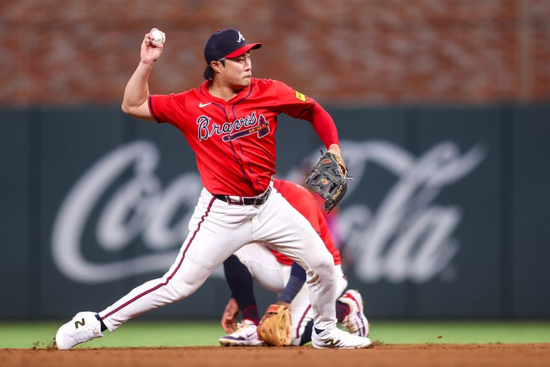 Sep 12, 2025; Atlanta, Georgia, USA; Atlanta Braves shortstop Ha-Seong Kim (9) throws a runner out at first against the Houston Astros in the fifth inning at Truist Park. Mandatory Credit: Brett Davis-Imagn Images
