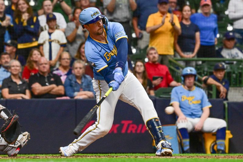 Sep 22, 2024; Milwaukee, Wisconsin, USA; Milwaukee Brewers first baseman Rhys Hoskins (12) drives in the tying run with a base hit in the eighth inning against the Arizona Diamondbacks at American Family Field. Mandatory Credit: Benny Sieu-Imagn Images