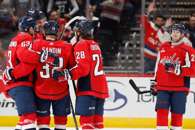 Sep 28, 2023; Washington, District of Columbia, USA; Washington Capitals defenseman Rasmus Sandin (38) celebrates with teammates after scoring a goal against the Detroit Red Wings third period at Capital One Arena. Mandatory Credit: Geoff Burke-USA TODAY Sports