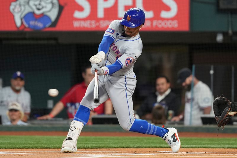 Jun 17, 2024; Arlington, Texas, USA; New York Mets shortstop Francisco Lindor (12) connects for a single against the Texas Rangers during the first inning at Globe Life Field. Mandatory Credit: Jim Cowsert-USA TODAY Sports