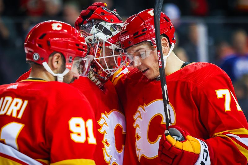 Mar 28, 2023; Calgary, Alberta, CAN; Calgary Flames goaltender Jacob Markstrom (25) and Calgary Flames right wing Walker Duehr (71) celebrates win over Los Angeles Kings at Scotiabank Saddledome. Mandatory Credit: Sergei Belski-USA TODAY Sports