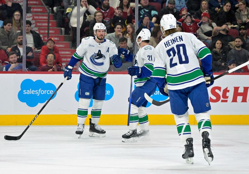 Jan 6, 2025; Montreal, Quebec, CAN; Vancouver Canucks forward J.T. Miller (9) celebrates with teammates after scoring a goal against the Montreal Canadiens during the first period at the Bell Centre. Mandatory Credit: Eric Bolte-Imagn Images