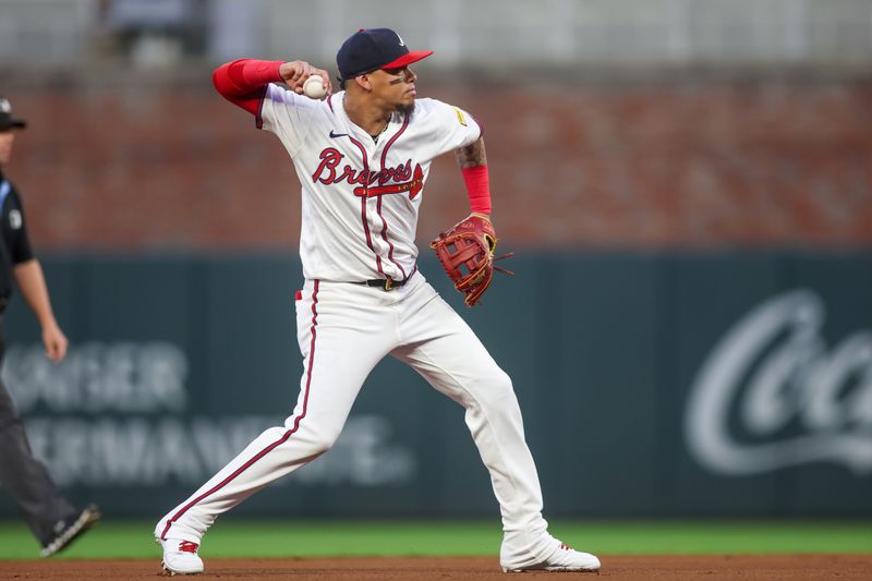 Sep 24, 2024; Atlanta, Georgia, USA; Atlanta Braves shortstop Orlando Arcia (11) throws a runner out at first against the New York Mets in the first inning at Truist Park. Mandatory Credit: Brett Davis-Imagn Images
