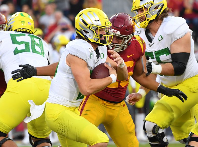 Nov 2, 2019; Los Angeles, CA, USA;  USC Trojans linebacker Kana'i Mauga (26) sacks  Oregon Ducks quarterback Justin Herbert (10) in the first quarter of the game against the Oregon Ducks at Los Angeles Memorial Coliseum. Mandatory Credit: Jayne Kamin-Oncea-USA TODAY Sports