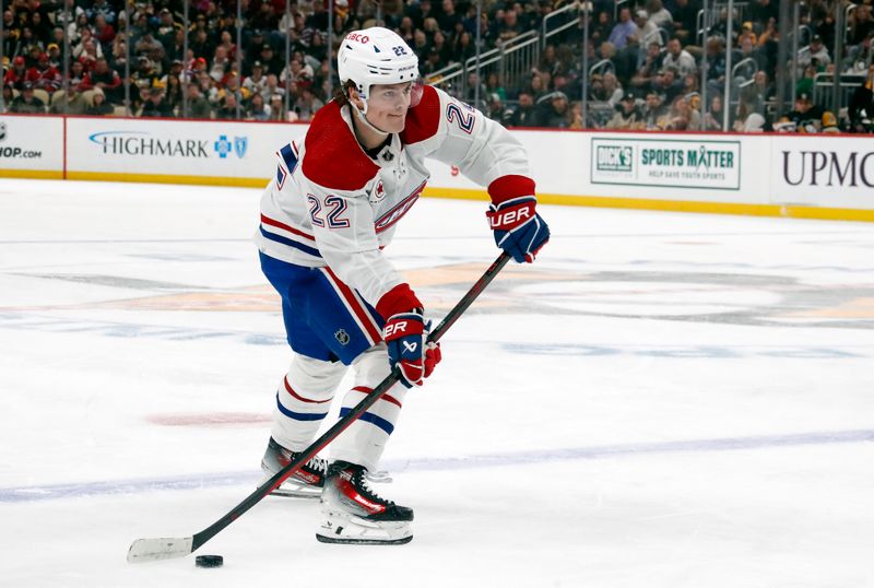 Jan 27, 2024; Pittsburgh, Pennsylvania, USA;  Montreal Canadiens right wing Cole Caufield (22) passes the puck against the Pittsburgh Penguins during the second period at PPG Paints Arena. Mandatory Credit: Charles LeClaire-USA TODAY Sports