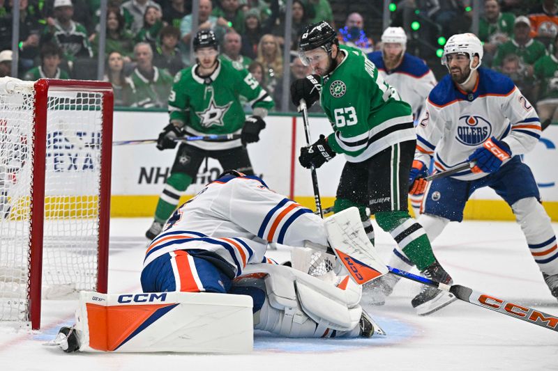 May 25, 2024; Dallas, Texas, USA; Edmonton Oilers goaltender Stuart Skinner (74) stops a shot by Dallas Stars right wing Evgenii Dadonov (63) during the second period in game two of the Western Conference Final of the 2024 Stanley Cup Playoffs at American Airlines Center. Mandatory Credit: Jerome Miron-USA TODAY Sports