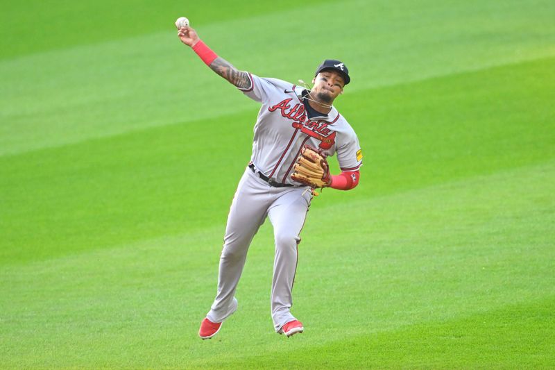 Jul 5, 2023; Cleveland, Ohio, USA; Atlanta Braves shortstop Orlando Arcia (11) throws to first base in the second inning against the Cleveland Guardians at Progressive Field. Mandatory Credit: David Richard-USA TODAY Sports