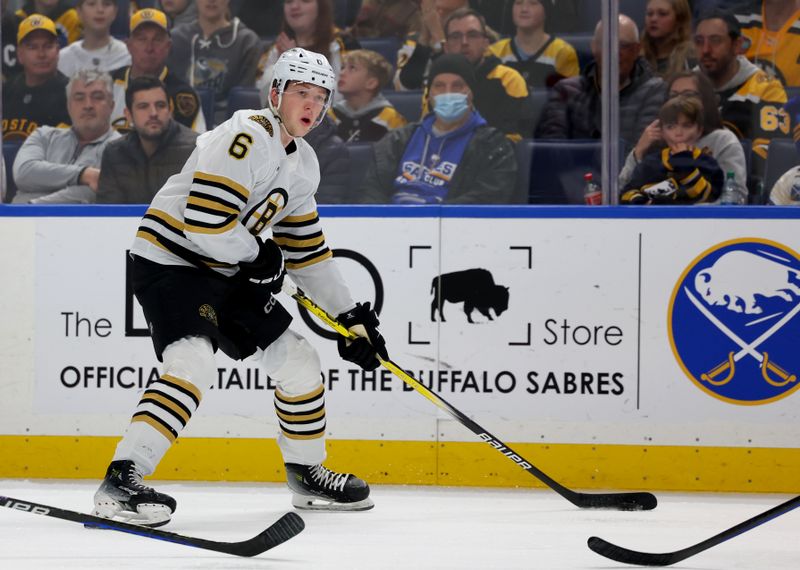 Dec 27, 2023; Buffalo, New York, USA;  Boston Bruins defenseman Mason Lohrei (6) looks to make a pass during the first period against the Buffalo Sabres at KeyBank Center. Mandatory Credit: Timothy T. Ludwig-USA TODAY Sports