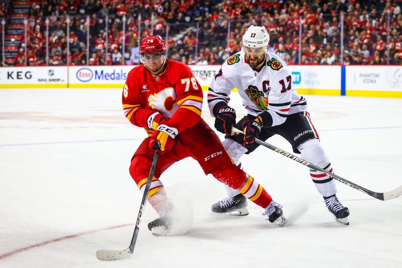 Oct 15, 2024; Calgary, Alberta, CAN; Calgary Flames center Martin Pospisil (76) and Chicago Blackhawks left wing Nick Foligno (17) battles for the puck during the third period at Scotiabank Saddledome. Mandatory Credit: Sergei Belski-Imagn Images