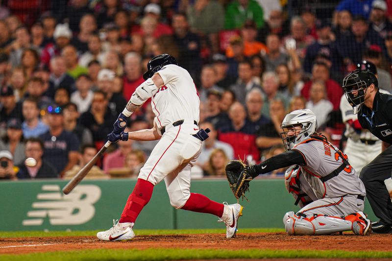 Sep 11, 2024; Boston, Massachusetts, USA; Boston Red Sox left fielder Tyler O'Neill (17) his a three run home run to win the game against the Baltimore Orioles in ten innings at Fenway Park. Mandatory Credit: David Butler II-Imagn Images