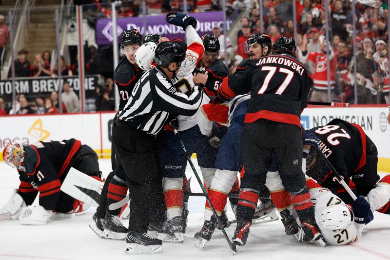 May 28, 2025; Raleigh, North Carolina, USA; Florida Panthers defenseman Nate Schmidt (88) and forward Eetu Luostarinen (27) and Carolina Hurricanes defenseman Alexander Nikishin (21) and forward Eric Robinson (50) and forward Mark Jankowski (77) fight in front of goaltender Frederik Andersen (31) net during the first period in game five of the Eastern Conference Final of the 2025 Stanley Cup Playoffs at Lenovo Center. Mandatory Credit: Geoff Burke-Imagn Images