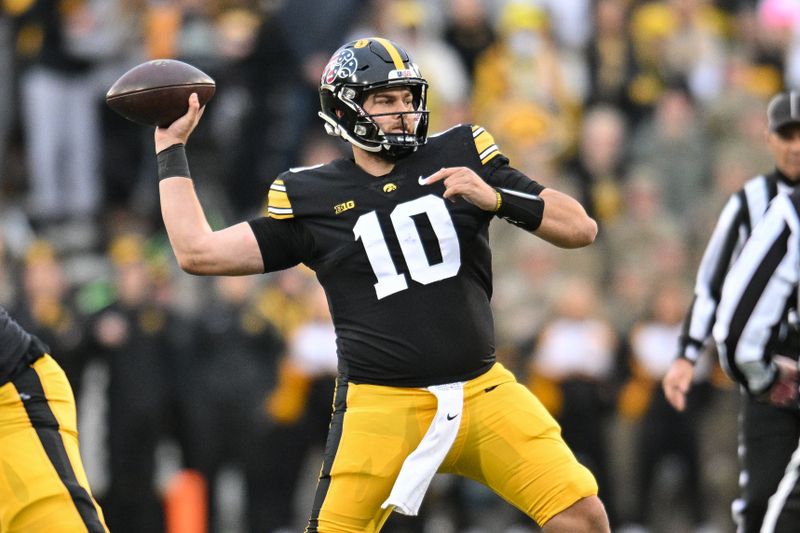 Nov 11, 2023; Iowa City, Iowa, USA; Iowa Hawkeyes quarterback Deacon Hill (10) throws a pass against the Rutgers Scarlet Knights during the second quarter at Kinnick Stadium. Mandatory Credit: Jeffrey Becker-USA TODAY Sports